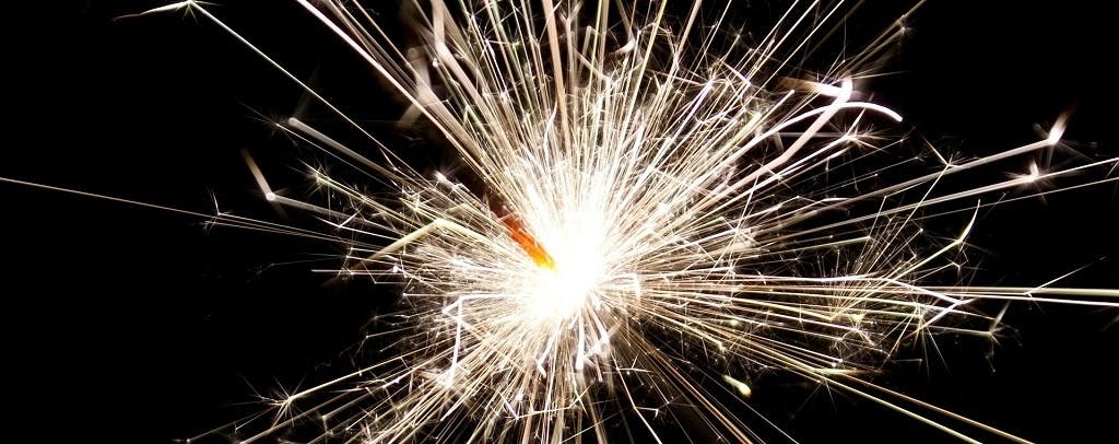 Close up of a lit sparkler with black background