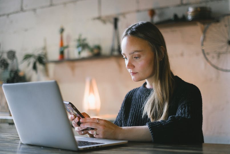 Woman at computer and phone 2 factor authentication