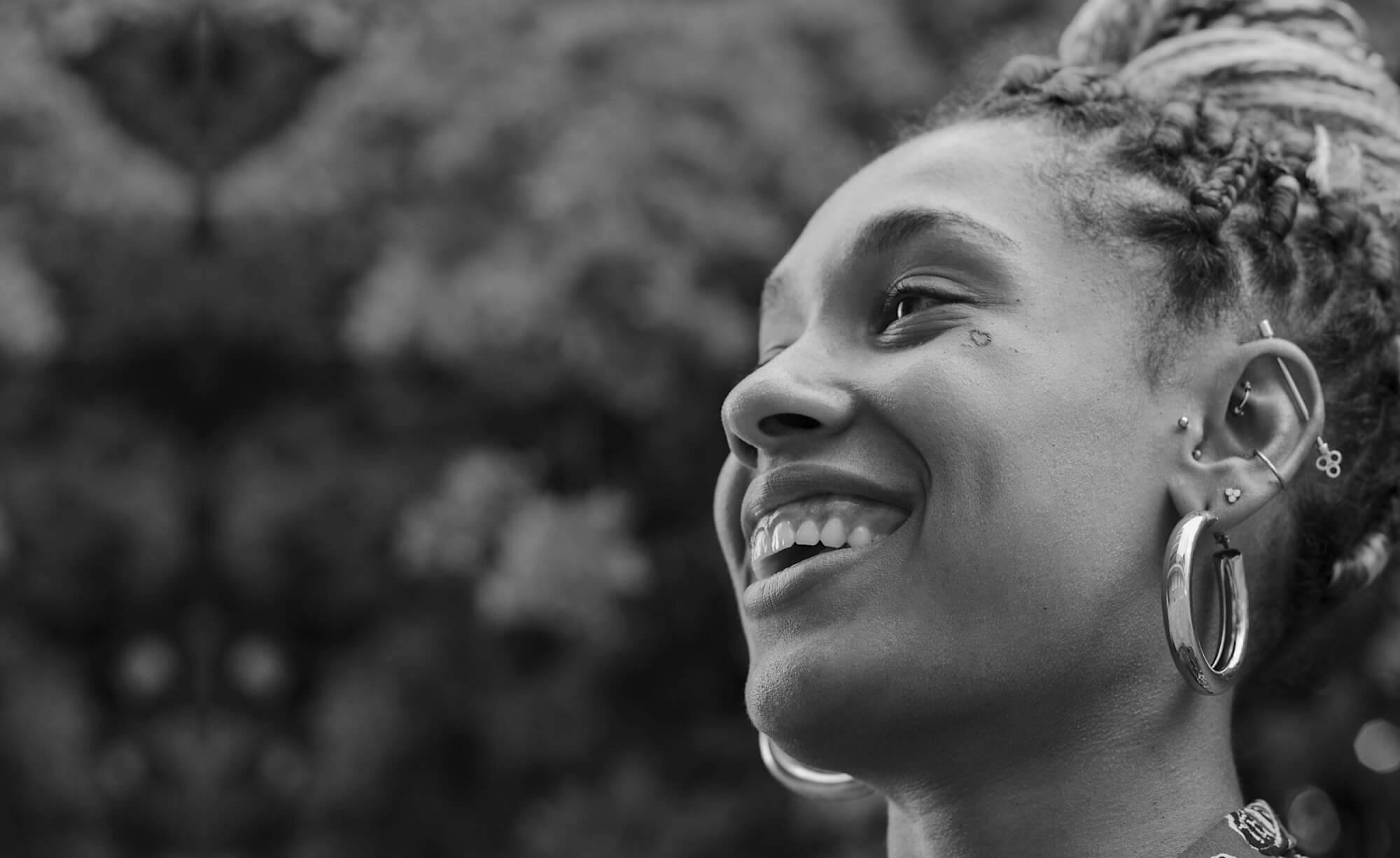 A smiling woman with large earrings.