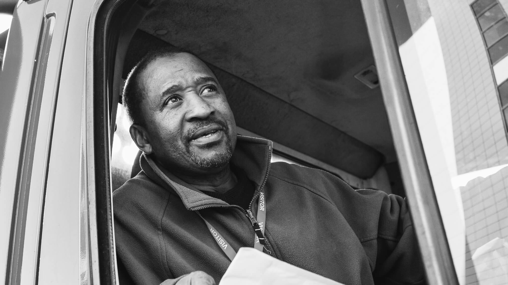 A man looks out a car window